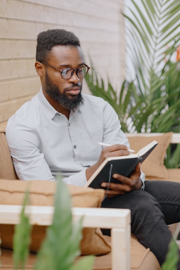 An African-American businessman works with a laptop or notebook, takes notes and notes in an office