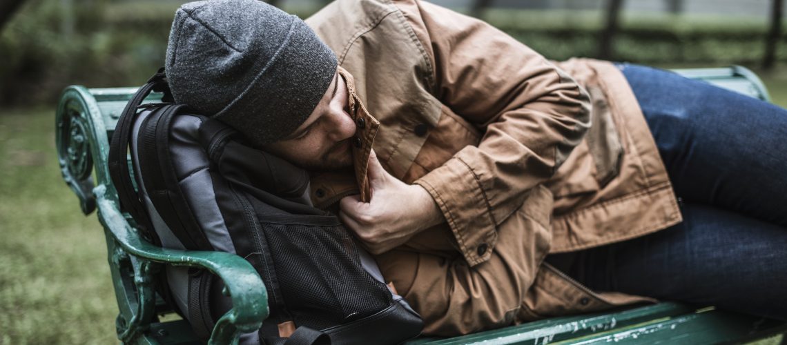Homeless Adult Man Sleeping on Bench in The Park